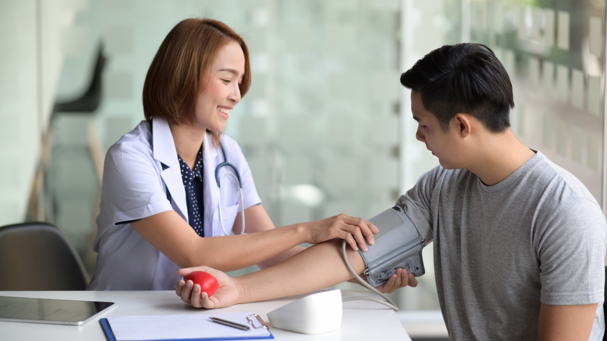Nurse checking a man's blood pressure with an arm cuff